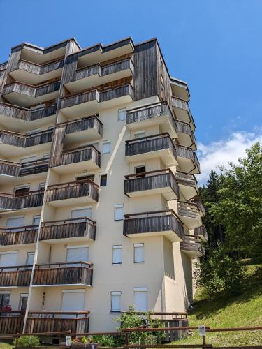 un grand bâtiment blanc avec des balcons dans l'établissement Prapoutel les 7 Laux, à Les Adrets