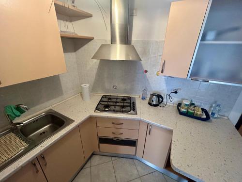 a small kitchen with a stove and a sink at Apartment with private parking spot in Oristano's city center in Oristano