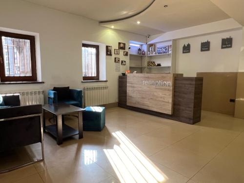 a waiting room with a reception desk in a building at Saryan Hotel Yerevan in Yerevan