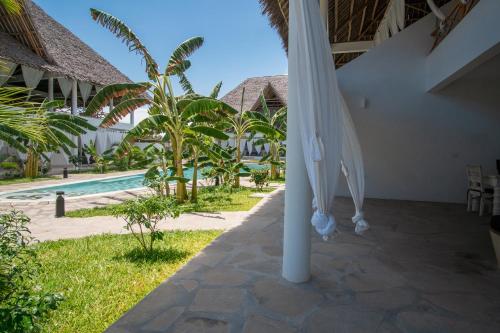 a view of the pool from the patio of a resort at Rafiki Tamu Residential Resort in Watamu
