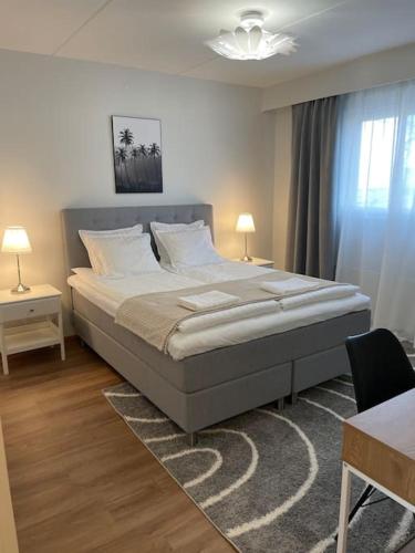 a bedroom with a large bed and a table and a desk at Nice and spacious condo in Helsinki