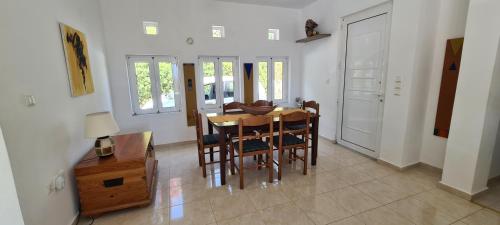a dining room with a wooden table and chairs at Villa Nisi in Agia Galini