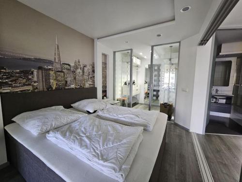 a large white bed in a bedroom with a city skyline at Luxurious Apartment in Mainz in Mainz