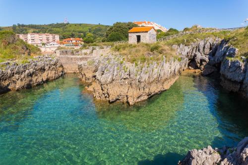 an aerial view of a body of water between rocks at Apartamentos Astuy in Isla