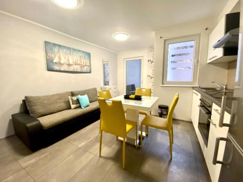 a living room with a table and a couch at Apartments Suzi Crikvenica in Crikvenica
