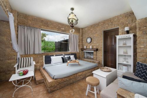 sypialnia z dużym łóżkiem i ceglaną ścianą w obiekcie Evi's Afandou Suite w mieście Afandu