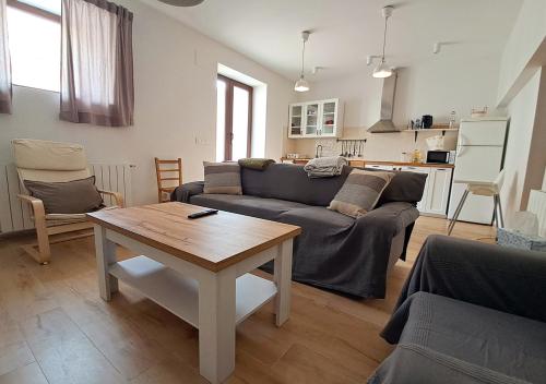 a living room with a couch and a table at Casa Mesones in Peñas de San Pedro