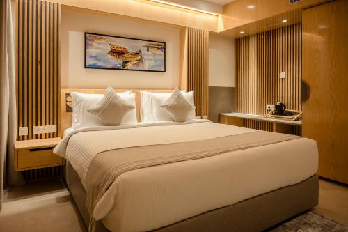 a bedroom with a large bed with white pillows at HOTEL LAKE VIEW in Baharampur
