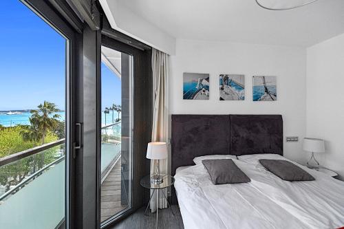 a bedroom with a bed with a view of the ocean at 7 Croisette in Cannes