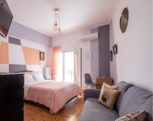 een slaapkamer met een bed en een bank bij Diana's apartment in Athene