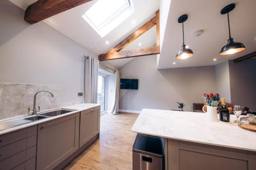 a kitchen with a sink and a counter top at Meadow View near Settle. Short walk to food pub in Settle
