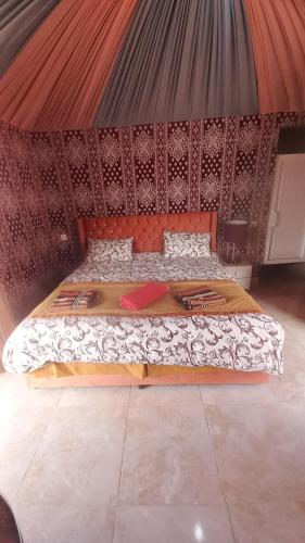 a bedroom with a bed in a tent at Sultan Luxury Camp in Wadi Rum