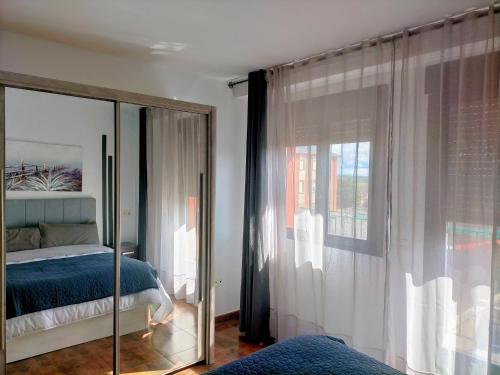 a bedroom with a bed and a mirror at Piso turistico el Sol VUT-983 in Astorga