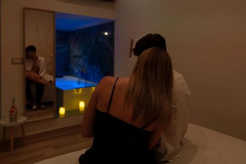 a woman is looking at herself in a mirror at Vicolo 107 in Sannicandro di Bari
