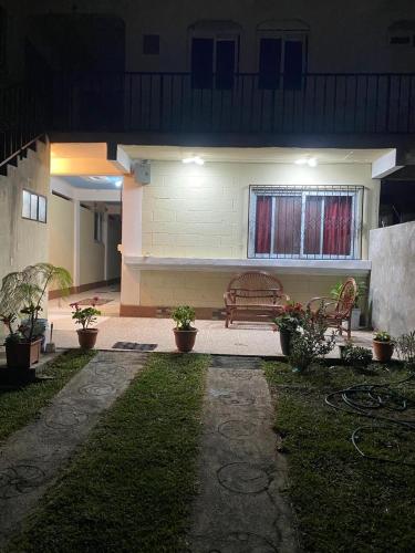 a bench in front of a house at night at Casa Julián Cotuc in San Juan La Laguna