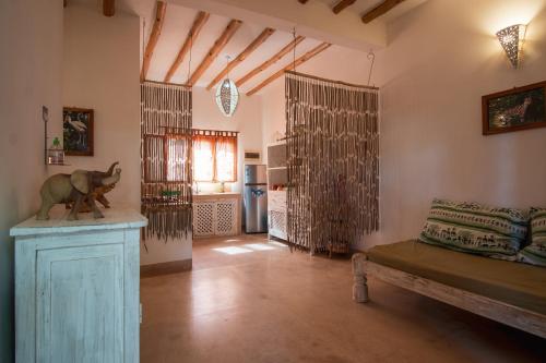 a living room with a couch and a table in a room at Rafiki Village in Watamu