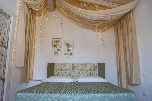 a bedroom with a bed with a canopy at Dimore Santagaeta in Racale