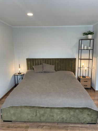 a bedroom with a large bed with two lamps at apartment SPRING in Cēsis
