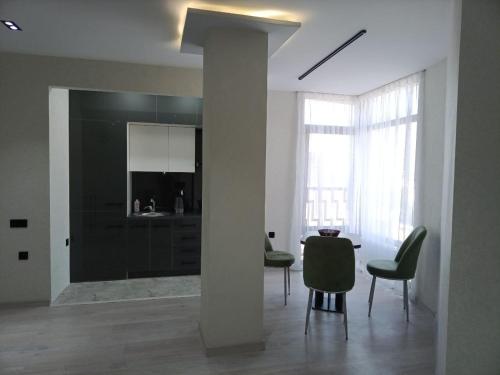 een woonkamer met een tafel en stoelen en een zuil bij Comfortable Apartment in Tasjkent