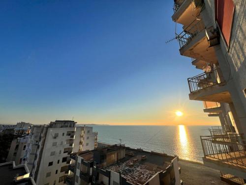 a view of the ocean from between buildings at Beach Home Retreat in Durrës