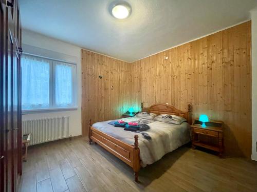 a bedroom with a bed with two blue lights on it at Maggioni Silvia in Tarvisio