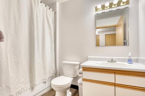 a bathroom with a toilet and a sink and a mirror at Quest Travels in Seattle