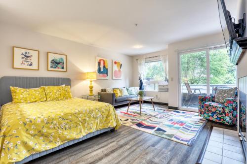 a bedroom with a yellow bed and a living room at Quest Travels in Seattle