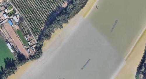 an overhead view of a beach with a field and water at Villa Dársena in Seville