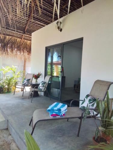 a living room with chairs and a table at Chagres River Lodge in Santa Rosa