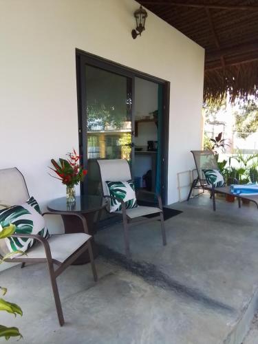 a patio with chairs and a table and a window at Chagres River Lodge 