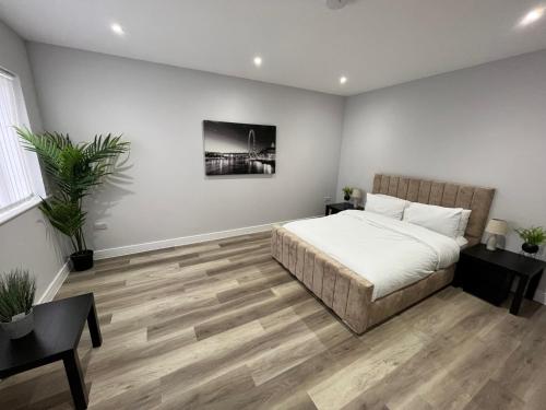 a bedroom with a bed and a wooden floor at Apartment 2 Castle Lane in Bournemouth
