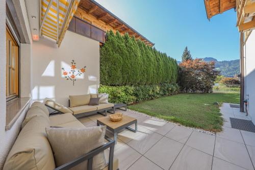 a patio with a couch and a table at Chalet Kitzbühelblick in Kitzbühel
