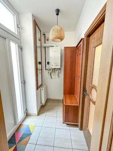 a hallway with a door and a tile floor at Zen Studio - Edge of Old Town with Free Private Parking in Braşov