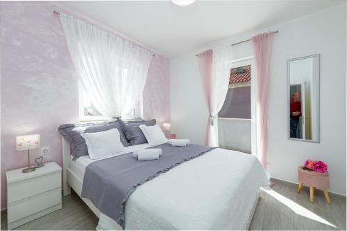 a bedroom with a large bed and a window at Apartments Lana in Mlini