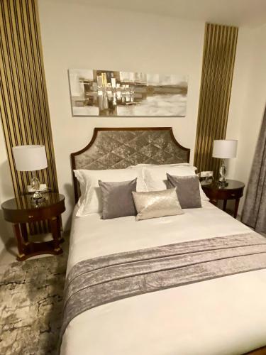 a bedroom with a large white bed with two tables at Guesthouse Villa Vice in Split