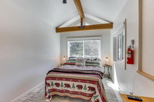 a bedroom with a bed in a room with a window at Big Bear Lake Condo with Deck, Steps to Ski Lift in Big Bear Lake