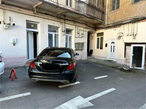 a car parked in a parking lot next to a building at Zen Studio in Braşov