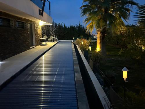 a walkway leading to a house at night at COTTAGE MARIN avec VUE MER in Nice