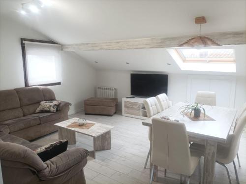 a living room with a couch and a table at Bejar Alojamiento La Plaza in Béjar