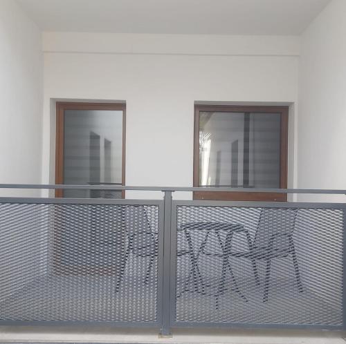 a balcony with a table and two windows at Studio Třeboň in Třeboň