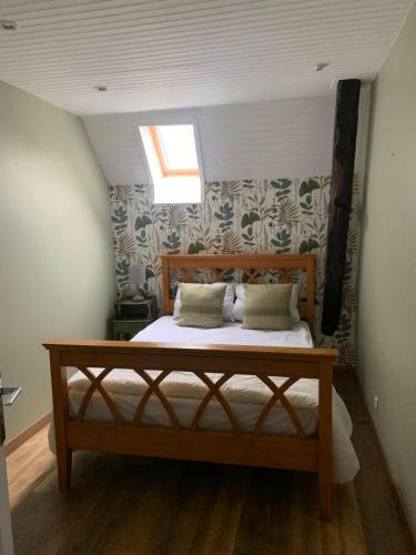 a bedroom with a bed in a attic with a window at Gite de la Renardière in Paunat