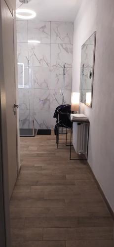 a hallway with a mirror and a piano in a room at "La Selvetta" bed and breakfast in Buguggiate