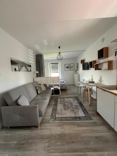 a living room with a couch and a table at Adventure Base A&B in Stronie Śląskie