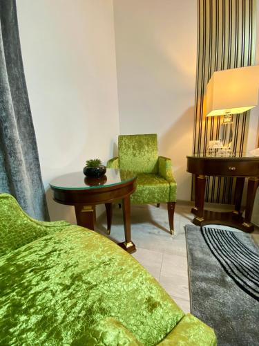 a living room with a bed and a table and a chair at Guesthouse Villa Vice in Split