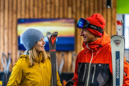 a man and a woman standing next to each other with skis at k1 sporthotel - Bike & Ski inklusive Hotel in Kurort Oberwiesenthal