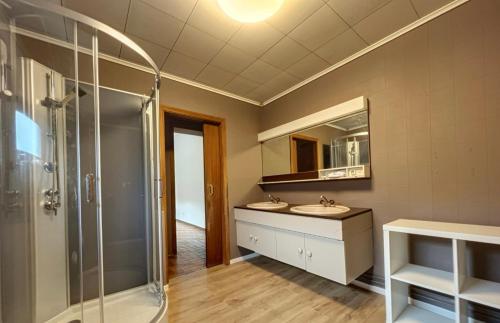 a bathroom with two sinks and a glass shower at Station 64 A1 Bruxelles-Charleroi-airport in Charleroi