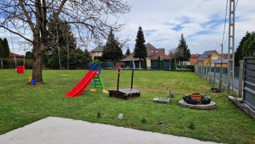 a park with a playground with a slide at Silence Apartmanház Zalakaros in Zalakaros