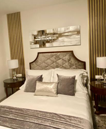 a bedroom with a large white bed with pillows at Guesthouse Villa Vice in Split
