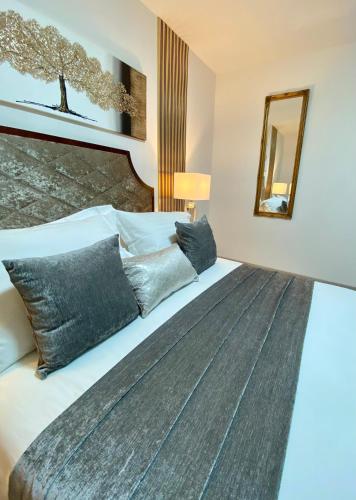 a bedroom with a large bed with a mirror at Guesthouse Villa Vice in Split