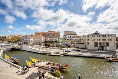 a group of boats in a river in a city at Casa Marques Apartments in Aveiro